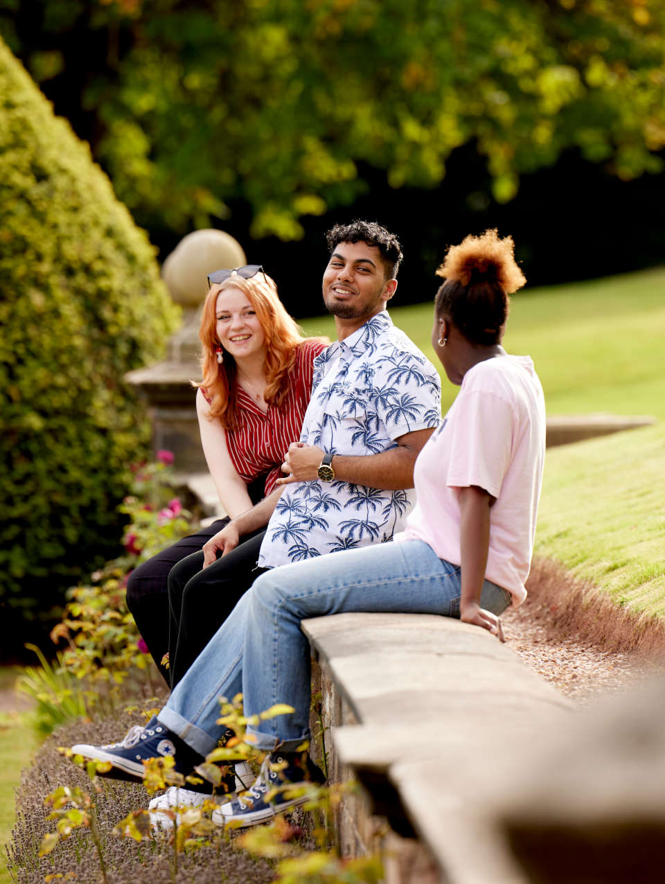Three students chatting on campus